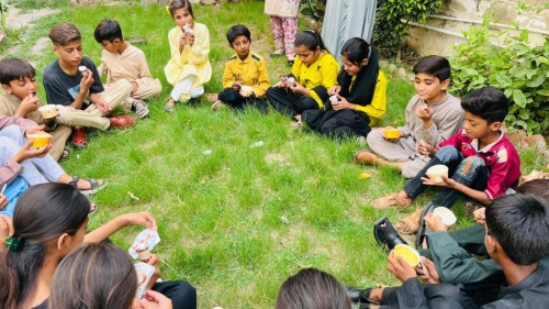 On June 12, Street Kids Funds' Multan Learning Center hosted a special ice cream party for the students before closing for the summer vacation. An ice cream truck visited the center, allowing students to choose their favorite flavors served in either cones or cups. The children enjoyed their treats together in the garden, making it a fun and memorable way to celebrate the start of the summer break.