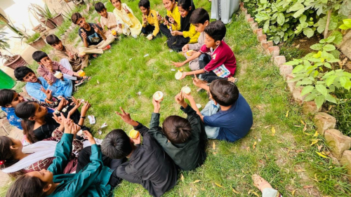 On June 12, Street Kids Funds' Multan Learning Center hosted a special ice cream party for the students before closing for the summer vacation. An ice cream truck visited the center, allowing students to choose their favorite flavors served in either cones or cups. The children enjoyed their treats together in the garden, making it a fun and memorable way to celebrate the start of the summer break.